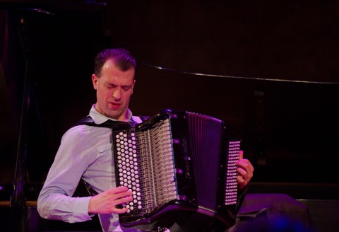 Julien Labro playing a chromatic button accordion, showing both button manuals