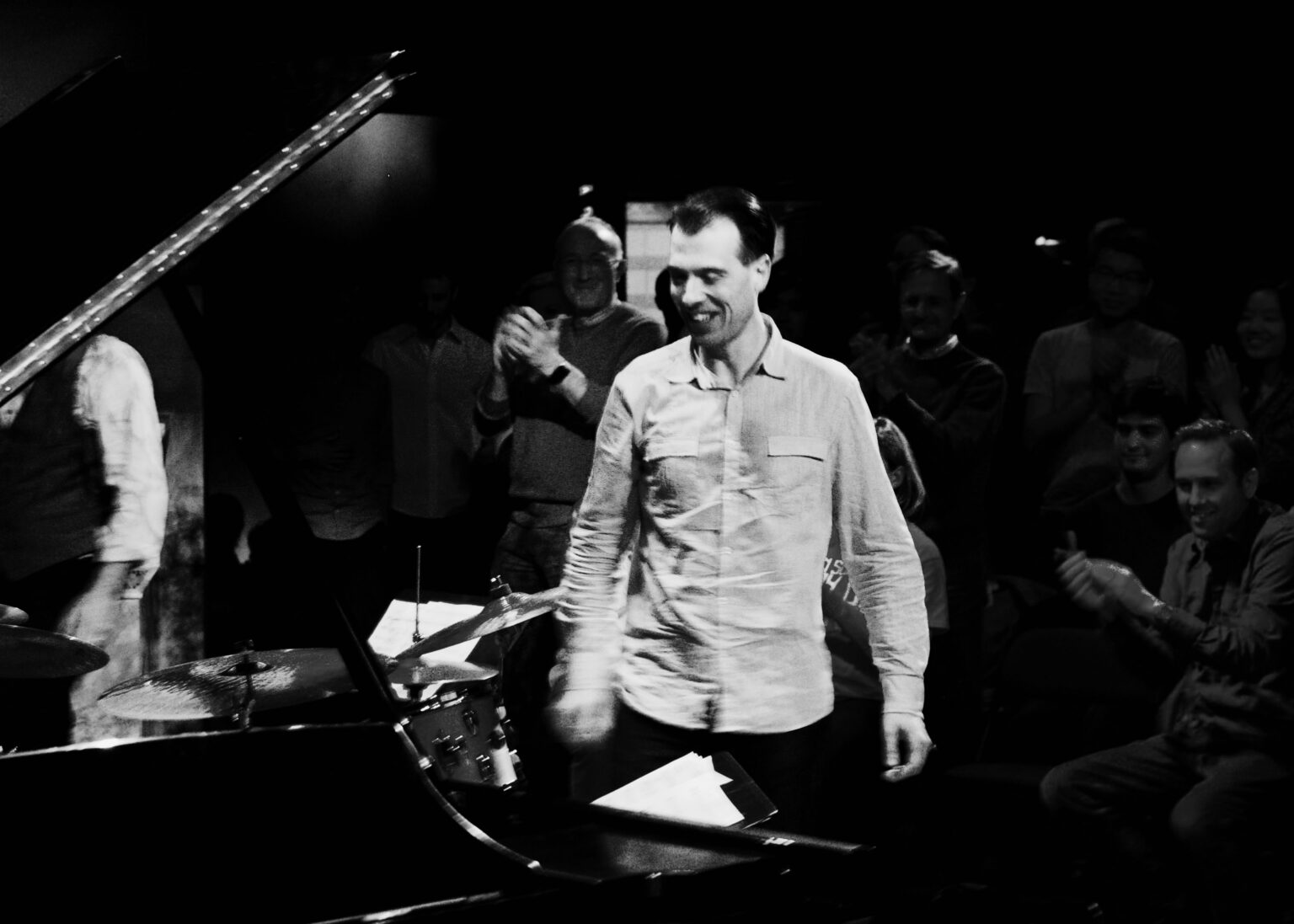 Julien Labro performing in an intimate jazz-club setting with piano and drums